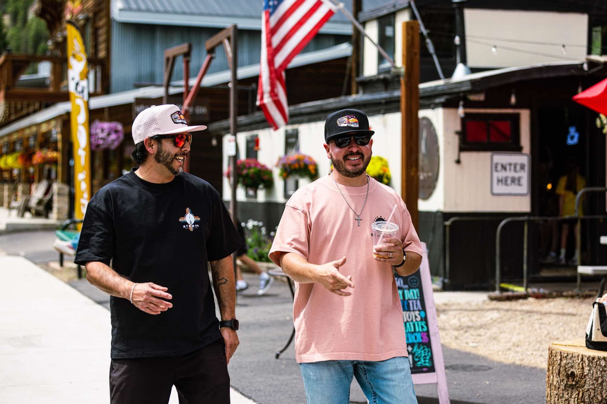 Two customers laughing outside Steam Coffee Co. on Main Street, Red River